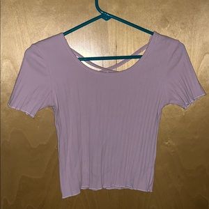 Pink crop top. Cross in back. Very nice quality.